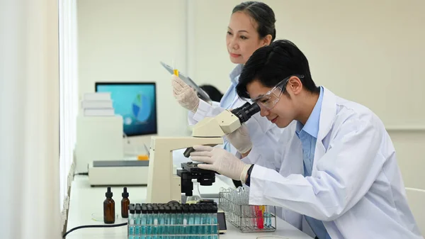 Young Male Microbiologist White Coat Looking Microscope Examining Samples Research — Foto Stock