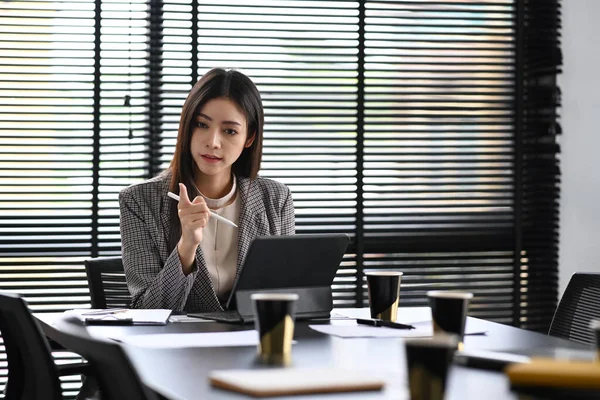 Experienced businesswoman explaining new marketing strategy during corporate meeting.