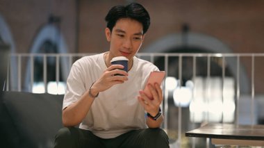 Handsome man chatting online, messaging on mobile phone. Technology, social network, communication concept.