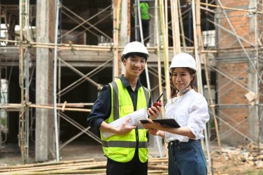 Female architects and engineer standing with arms crossed at construction site. Industry, Engineer, construction concept.