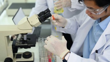 Young male biotechnology specialist conducting experiment in a laboratory. Concepts of medicine and science researching.