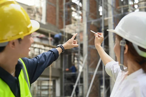 Female architects and civil engineer supervising progress of construction project together. Industry, Engineer, construction concept.