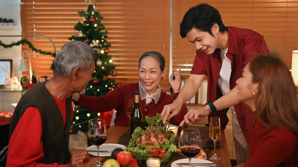 Happy family enjoying in Christmas meal in dining room. Christmas, New year, thanksgiving and celebration concept.