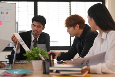 Yakışıklı erkek yönetici iş ortaklarını pazarlama atölyesindeki pazarlıklara ikna ediyor..