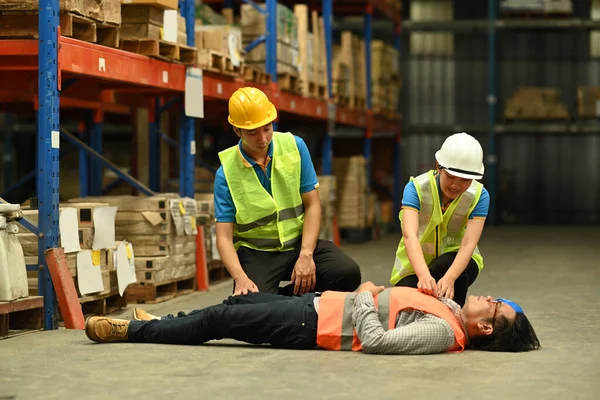 Middle Age Male Warehouse Worker Lying Unconscious Concrete Floor Colleagues — Stock Photo, Image