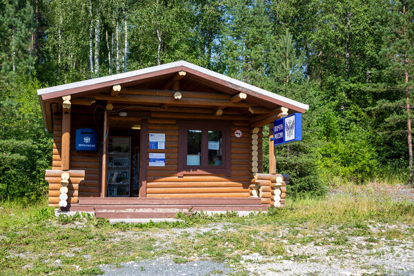 Рускеала, Россия - 10 июля 2021: Деревянный дом с вывеской "Почта России" на русском языке на фасаде