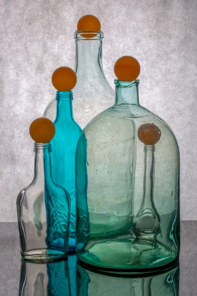 Still Life Different Transparent Glass Bottles Orange Balloons — Stock Photo, Image