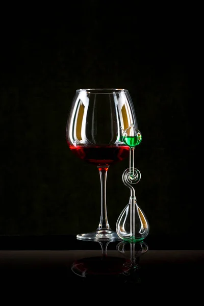 Still life with glass objects on a black background