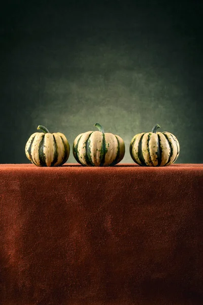 Three Striped Decorative Pumpkins Brown Table — Φωτογραφία Αρχείου