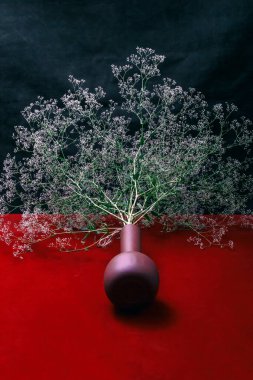 A large bouquet of wild flowers on the table in a brown vase
