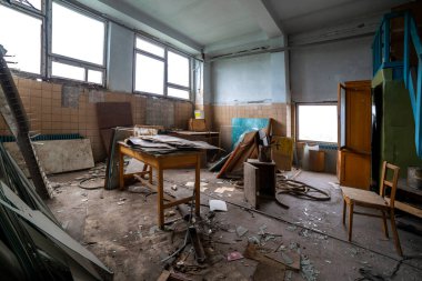 Broken furniture trash and clutter in an abandoned room