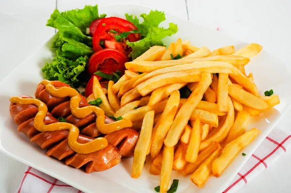 Potatoes fries and sausage — Stock Photo, Image