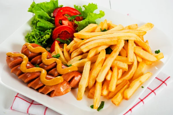 Potatoes fries and sausage — Stock Photo, Image