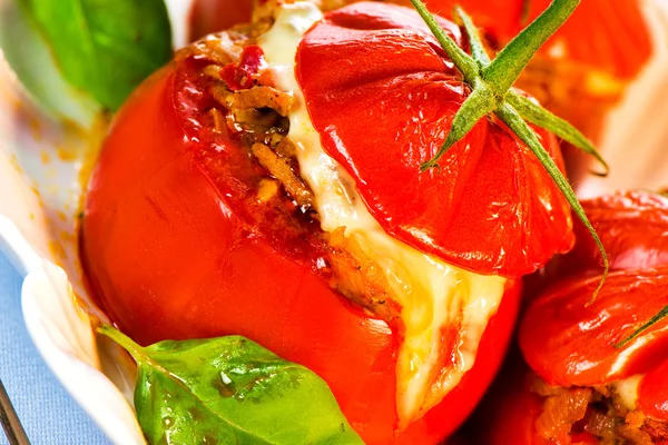 Three stuffed tomatoes on a white plate — Stock Photo, Image