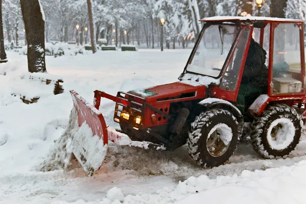 Snowplow Tractor cleaning snow in the park — Stock Photo, Image