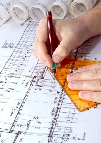 Architect drawing rolls and plans blueprints project — Stockfoto