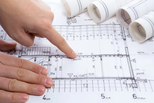 Architect drawing rolls and plans blueprints project — Stockfoto