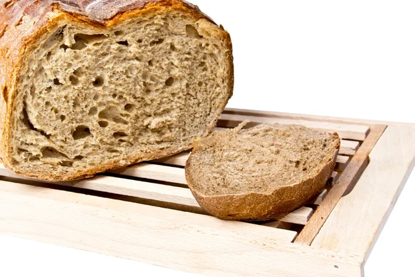 Fresh loaf of bread on cutting board white background — Stock Photo, Image