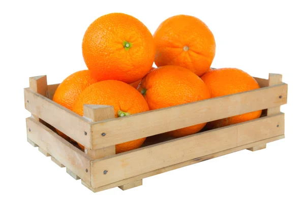 Fresh and ripe orange fruits in a wooden crate isolated on white background — Stock Photo, Image