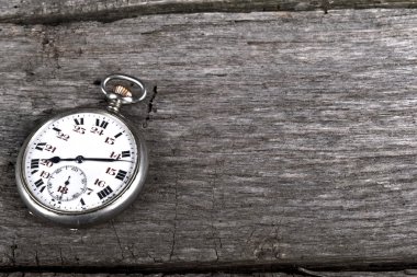 Vintage pocket watch on old wood