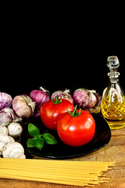 Pasta ingredients on black background italian cuisine concept — Stock Photo, Image