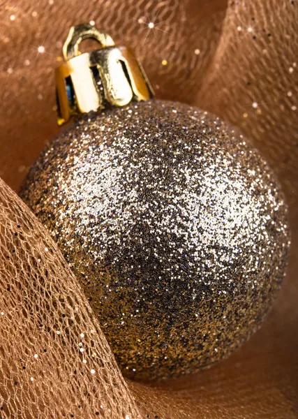 Golden christmas ball on wood — Stock Photo, Image