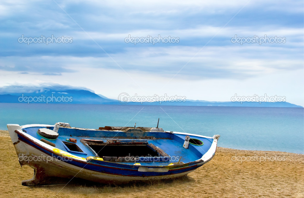 Fishing boat on beach sand ocean morning sky