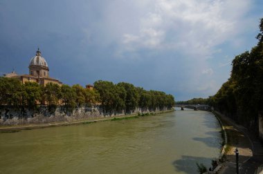 Photo of the Tiber River, church Chiesa Parrocchiale di San Giovanni Battista dei Fiorentini and bridge Ponte Giuseppe Mazzini in Rome