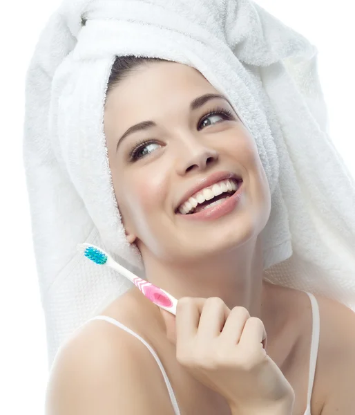 Smiling woman is brushing her teeth — Stock Photo, Image