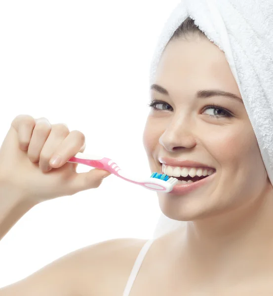 Smiling woman is brushing her teeth — Stock Photo, Image