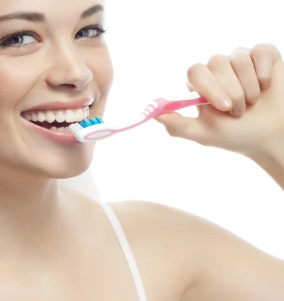 Smiling woman is brushing her teeth — Stock Photo, Image