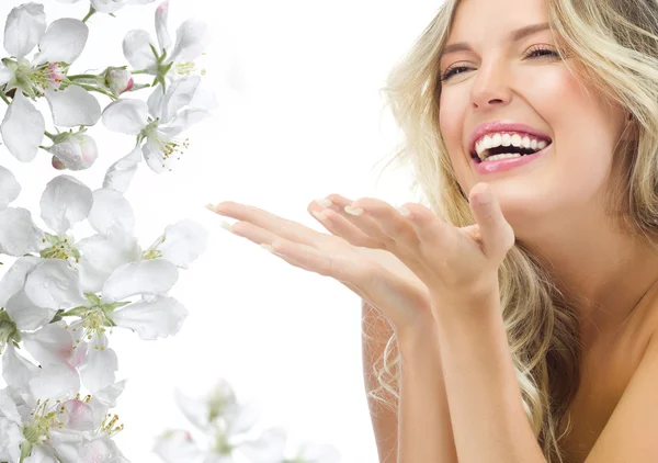 Blond woman with blooming flowers — Stock Photo, Image