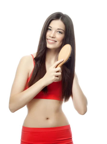 Woman is brushing her long hair — Stock Photo, Image