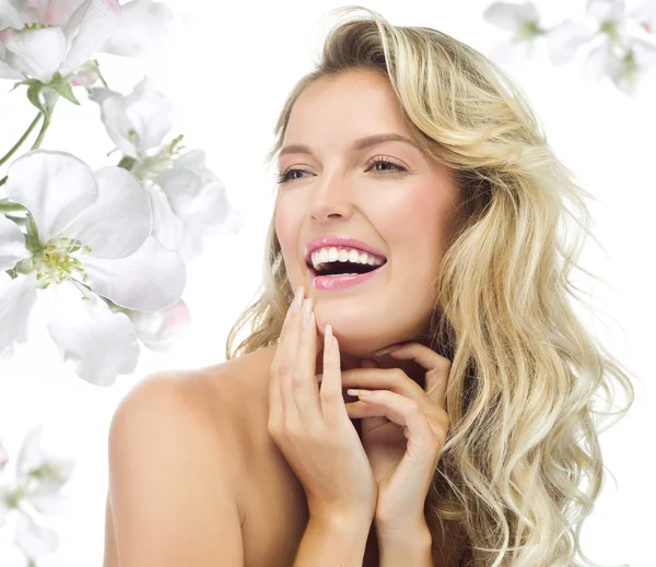 Blond woman with blooming flowers — Stock Photo, Image