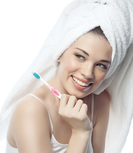 Smiling woman is brushing her teeth — Stock Photo, Image