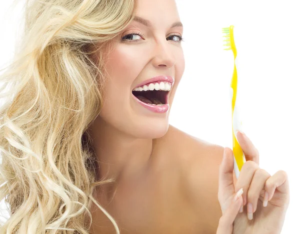 Smiling woman is brushing her teeth — Stock Photo, Image