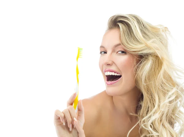 Smiling woman is brushing her teeth — Stock Photo, Image