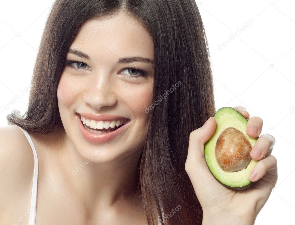 Smiling woman with with avocado