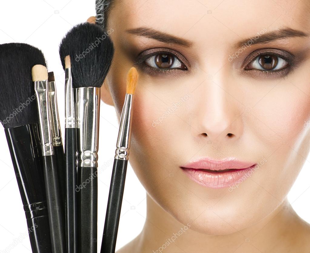 Woman with make up brushes