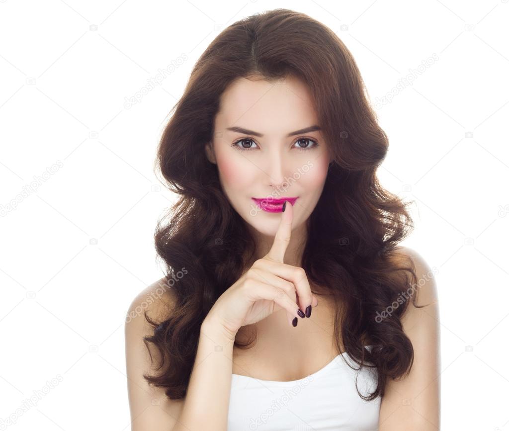 Woman with finger on her lips gesturing shh