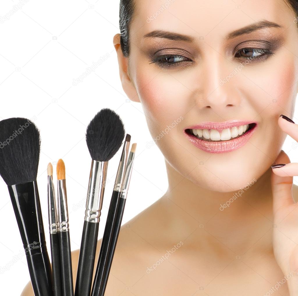 Woman with make up brushes