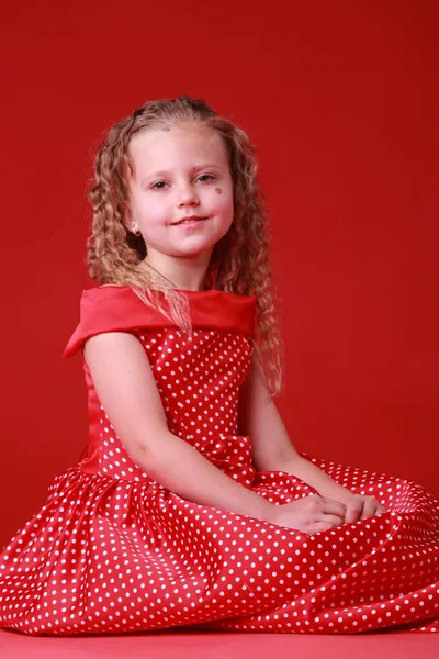 Little cute girl in a polka dot dress — Stock Photo, Image