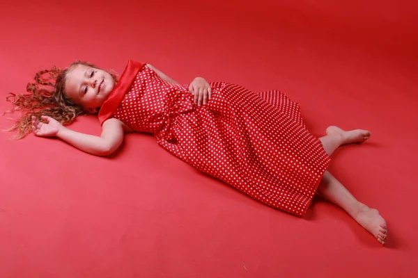 Little cute girl in a polka dot dress — Stock Photo, Image