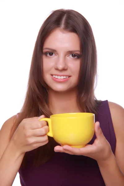 Young woman holding yellow tea cup — Stock Photo, Image