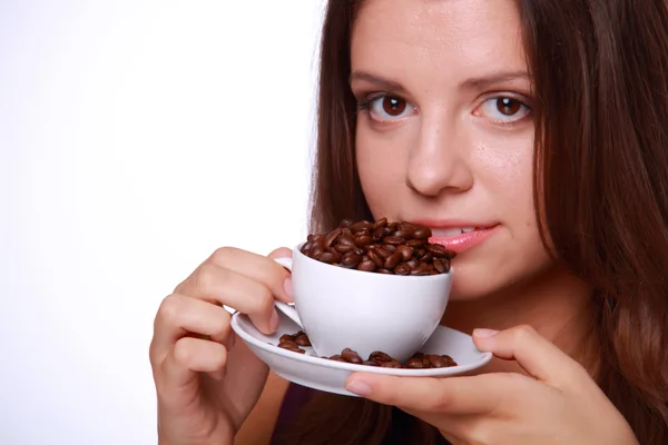 Young woman holding a cup of coffee beans Royalty Free Stock Images
