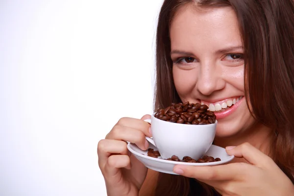 Young woman holding a cup of coffee beans Royalty Free Stock Photos