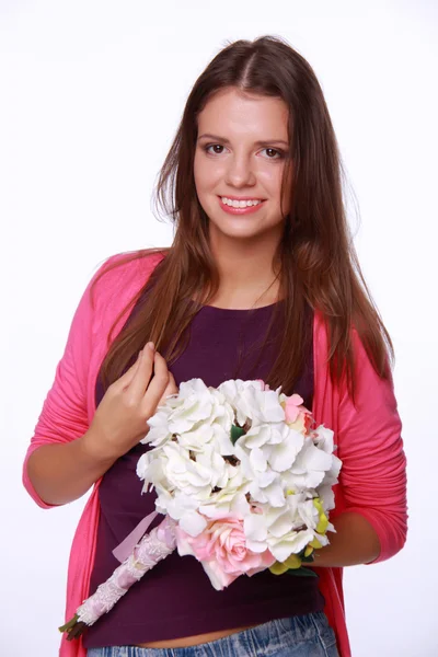Beautiful brunette in a pink blouse with a bouquet — Stock Photo, Image