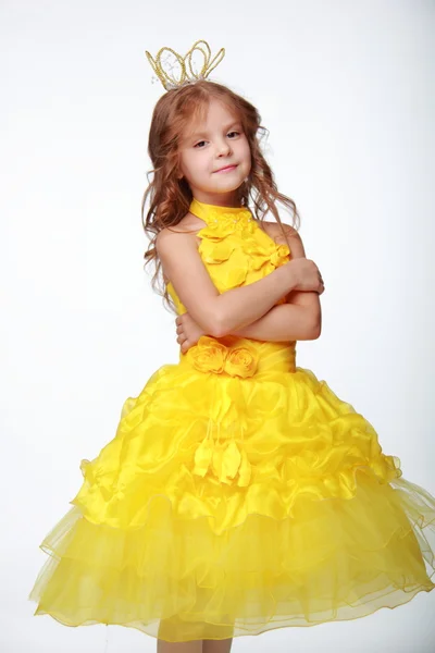 Little girl in a yellow dress and a crown — Stock Photo, Image