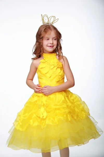 Little girl in a yellow dress and a crown — Stock Photo, Image