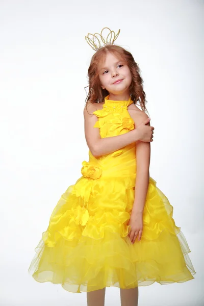 Little girl in a yellow dress and a crown — Stock Photo, Image